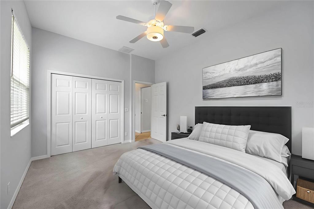 8204 Waterview Boulevard Lakewood Ranch, FL 34202 - Photo 32 of 77 a bedroom with a bed and a chandelier