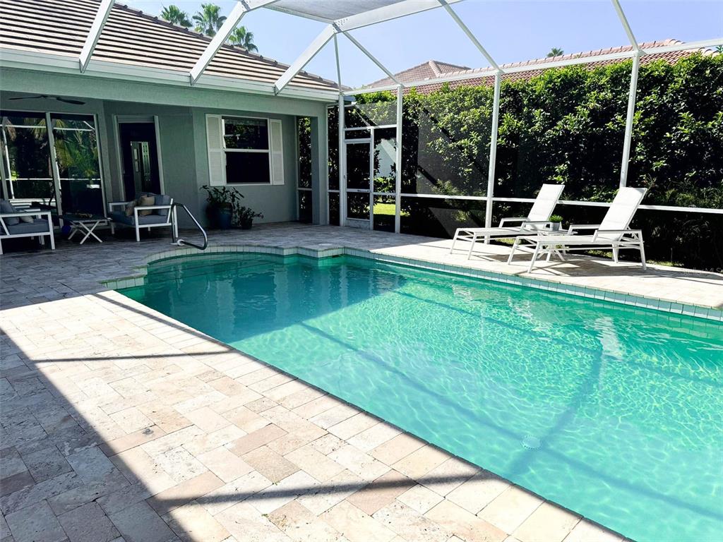 8204 Waterview Boulevard Lakewood Ranch, FL 34202 - Photo 43 of 77 a view of pool with table and chairs under an umbrella