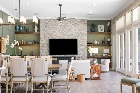 a living room with couches and a large window with outer view