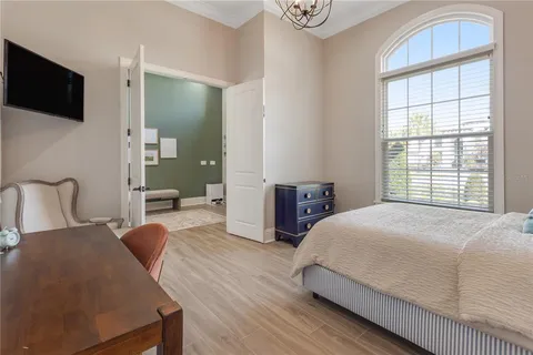 a spacious bedroom with a bed and glass door