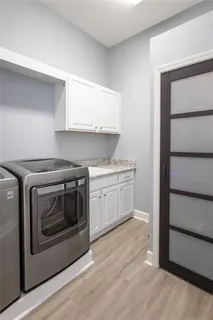 a spacious bathroom with a granite countertop sink a mirror and a bathtub