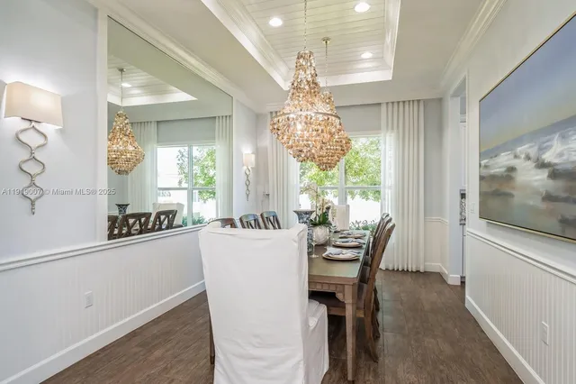 a dining room with furniture a chandelier and window