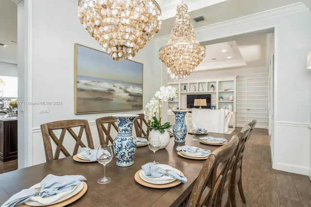 a view of a dining room with furniture wooden floor and chandelier