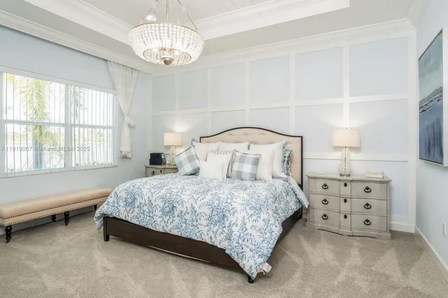 a bedroom with a bed a dresser and a large window