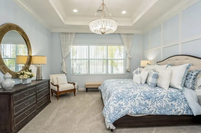 a bedroom with bed and a large windows