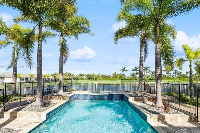 a view of a swimming pool with a table and chairs