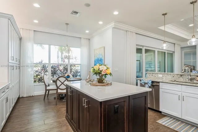 a kitchen with granite countertop a sink and cabinets