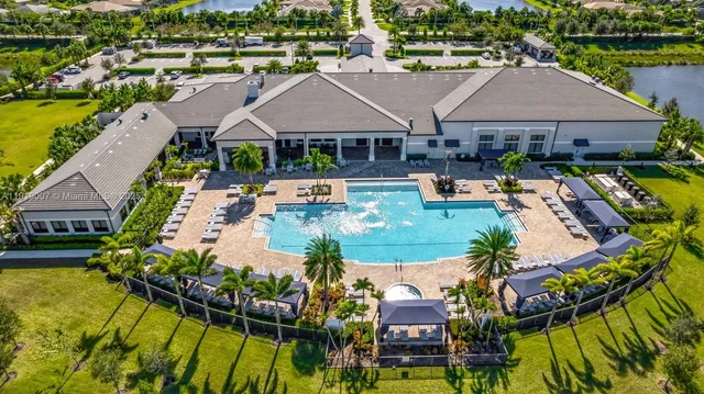 an aerial view of house with yard swimming pool and outdoor seating