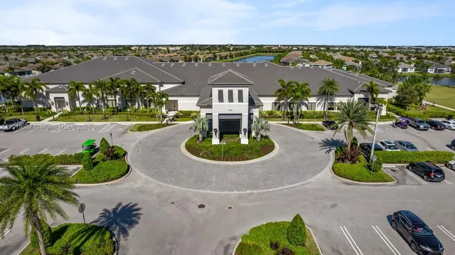 an aerial view of residential houses with outdoor space and parking