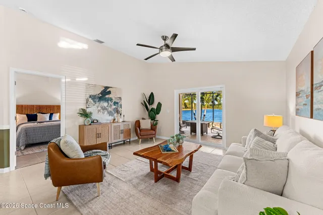 a living room with furniture and a potted plant
