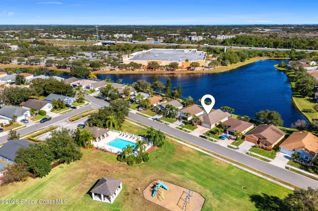 an aerial view of a house with a lake