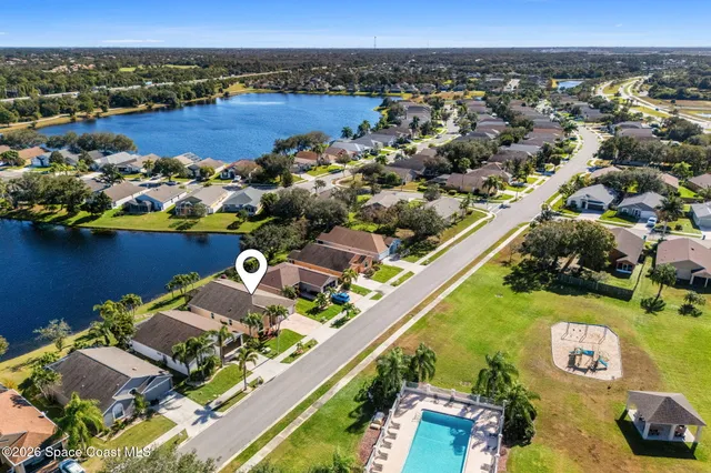 a front view of a house with garden and swimming pool