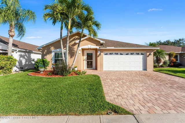 a aerial view of a house with garden space and lake view