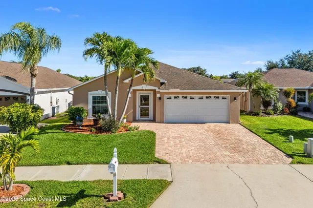 an aerial view of a house with a garden and lake view