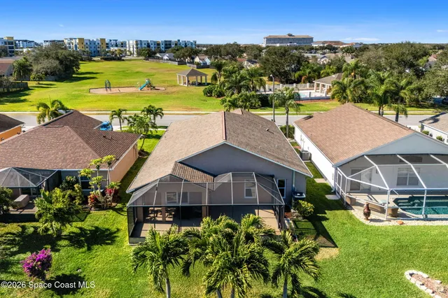 an aerial view of a house with a garden and houses