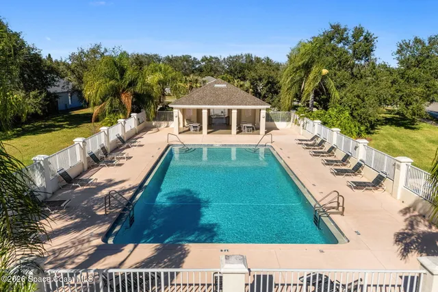 a view of a swimming pool with a yard