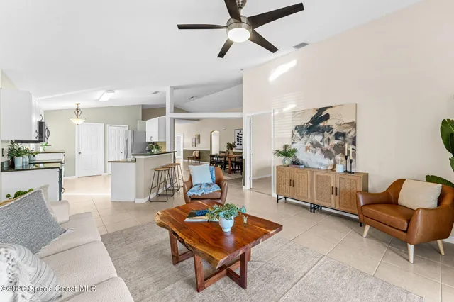 a living room with furniture and kitchen view