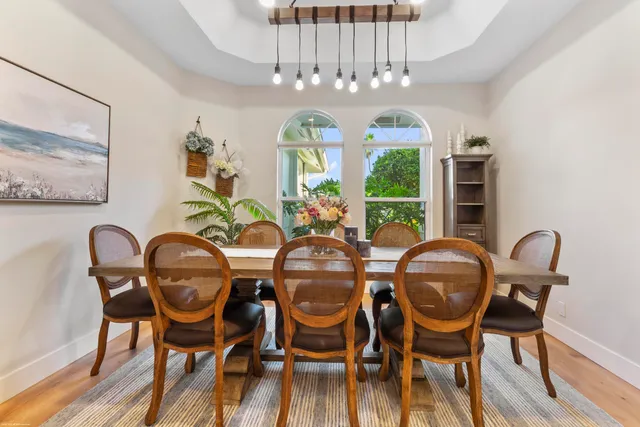 a dining room with furniture and a floor to ceiling window