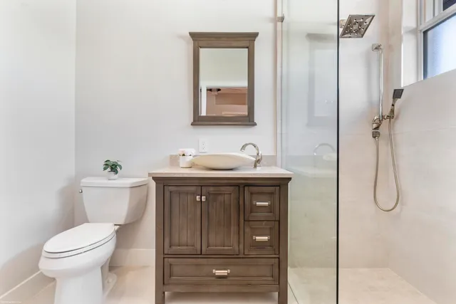 a bedroom with a bed a couch and a window