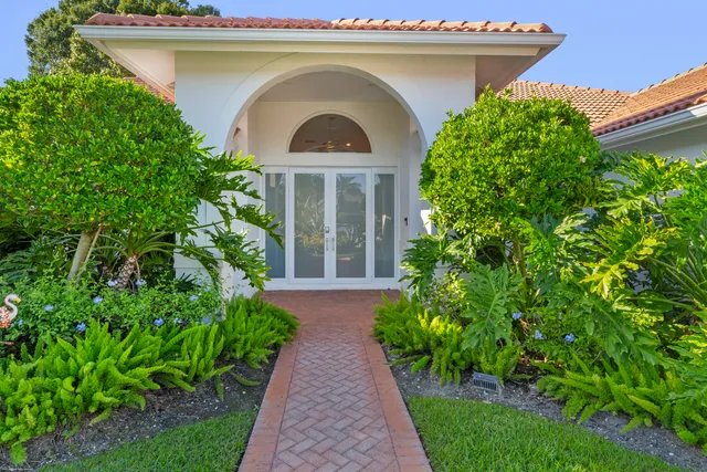 a view of a room with gym equipment and a chandelier