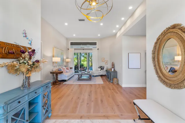 a living room with furniture a fireplace and a large window