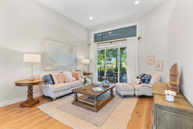 a kitchen with stainless steel appliances granite countertop a sink a stove and a wooden floors