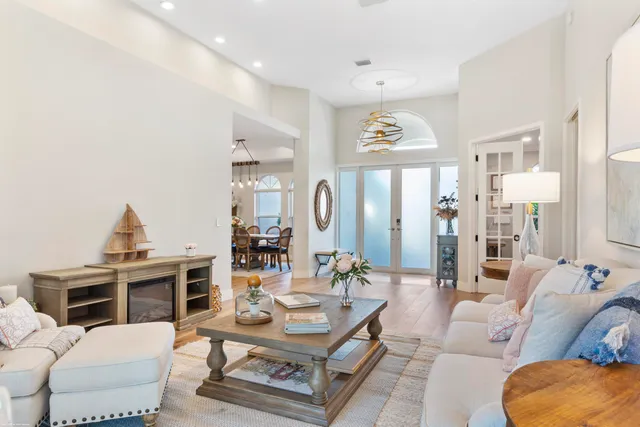 a kitchen with stainless steel appliances granite countertop a sink a stove a dining table and chairs