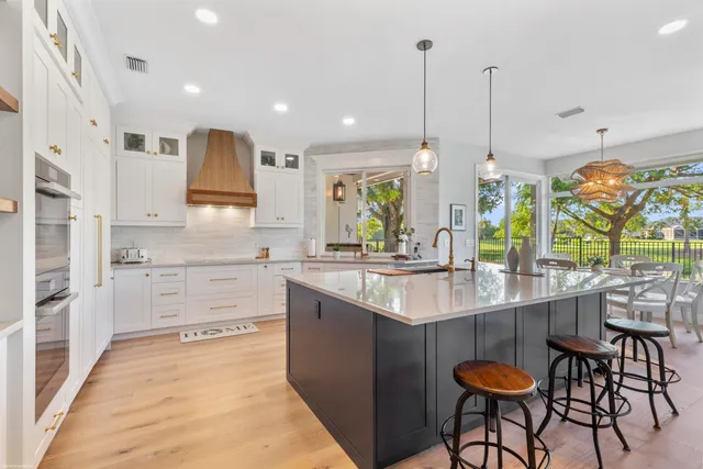 a living room with furniture fireplace and a large window