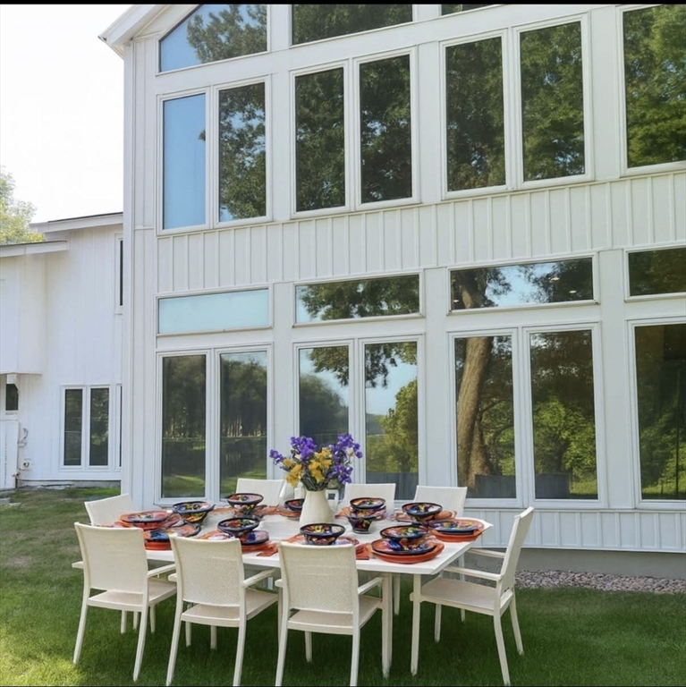 25 Sturges Road, Unit 1 Sharon, MA 02067 - Photo 2 of 11 a view of a patio with table and chairs and floor to ceiling window