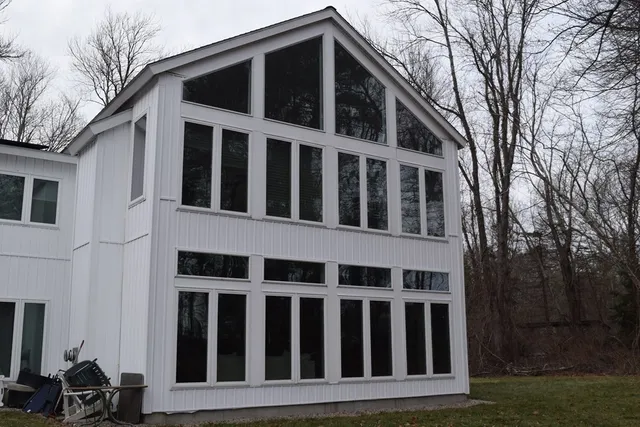 a view of a brick house with large windows