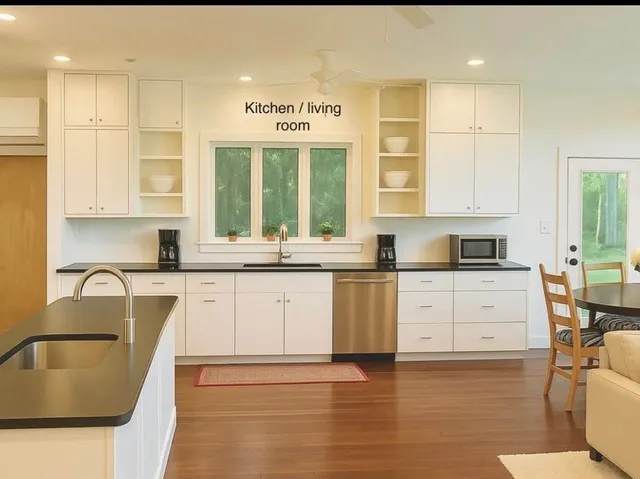 a kitchen with stainless steel appliances granite countertop a sink and cabinets