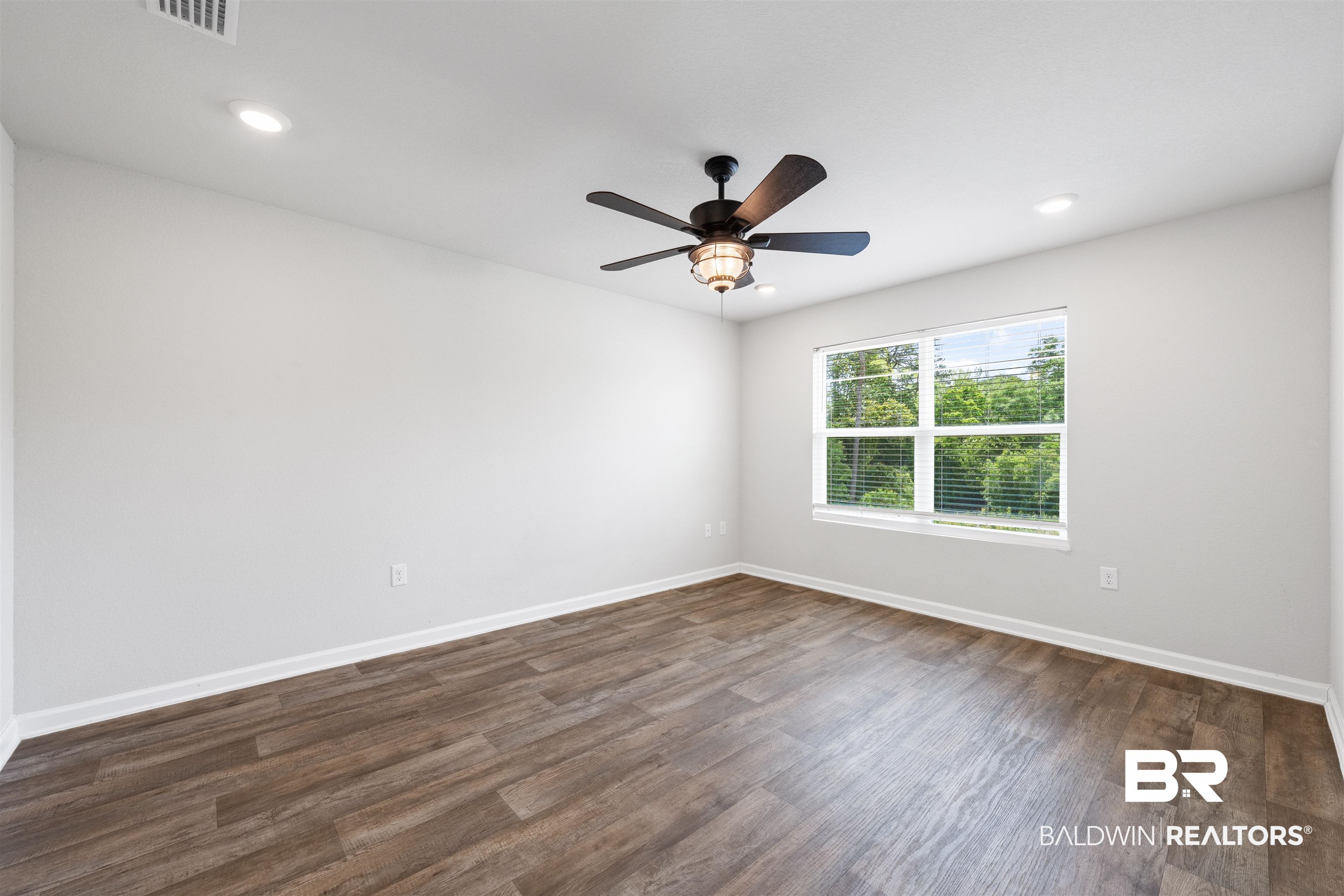 7457 Brompton Drive Foley, AL 36535 - Photo 10 of 24 Unfurnished room featuring dark wood finished floors, recessed lighting, and ceiling fan