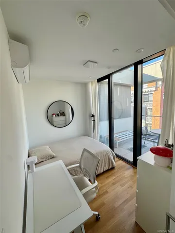 a bedroom with furniture and a large window