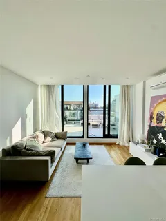 a living room with furniture and large windows