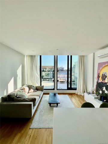 a living room with furniture and large windows