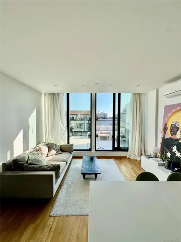 a living room with furniture and large windows