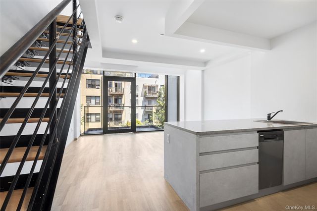 a view of an entryway with wooden floor and windows