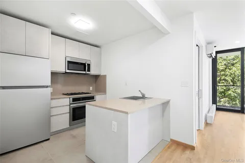 a kitchen with a sink appliances and cabinets