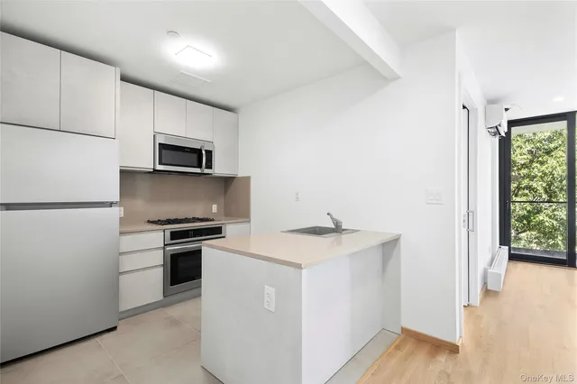 a kitchen with a sink appliances and cabinets