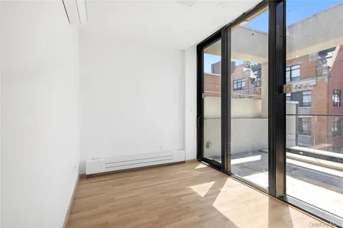a view of an empty room with floor to ceiling window