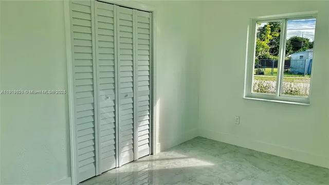 a view of an empty room with a window