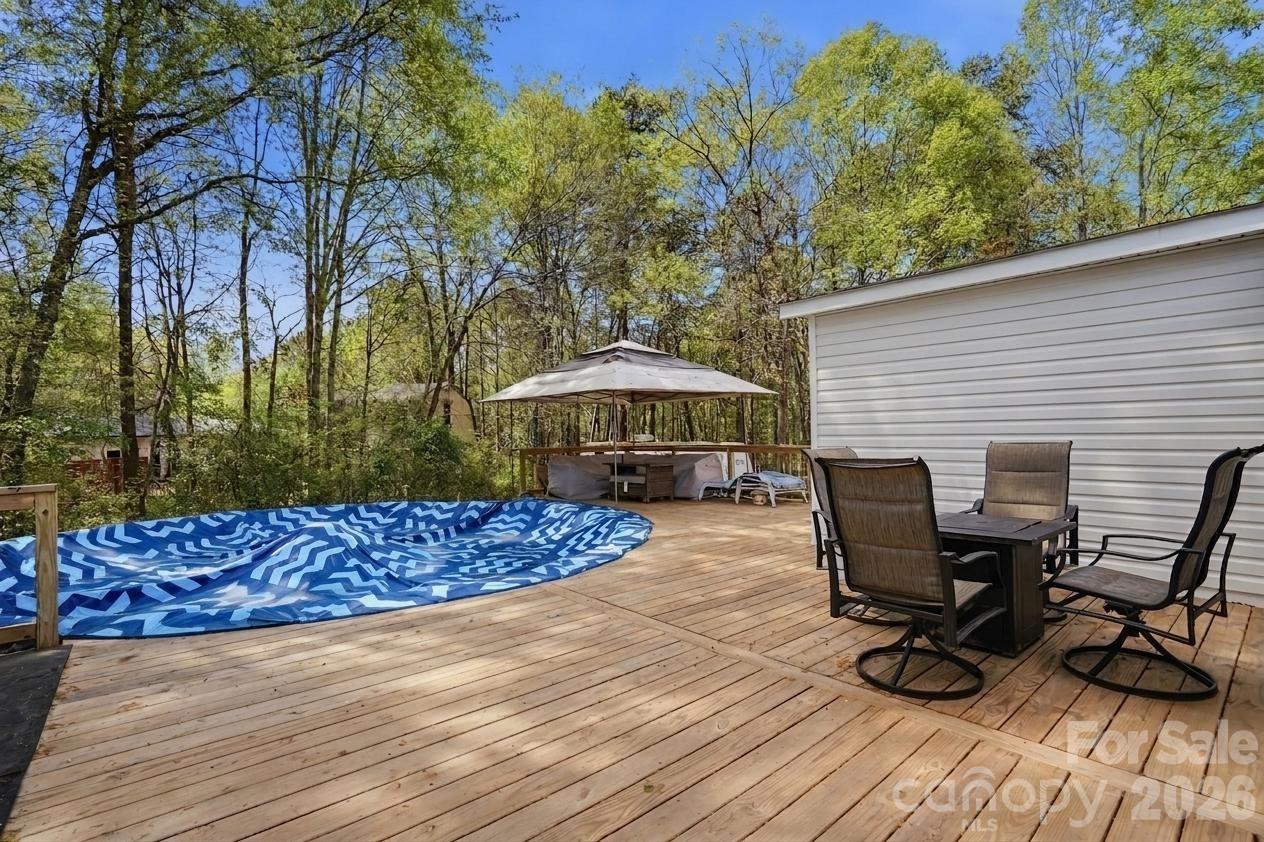 605 Ridgewood Court Mount Holly, NC 28120 - Photo 20 of 32 a view of a backyard with chairs and a patio