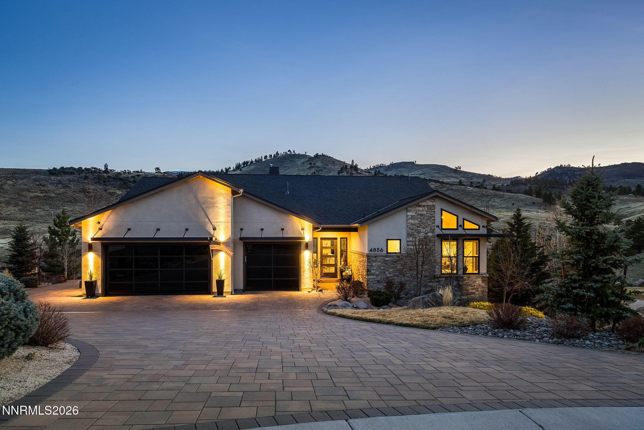 4856 Sierra Pine Court Reno, NV 89519 - Photo 1 of 71 a front view of a house with a yard and a garage