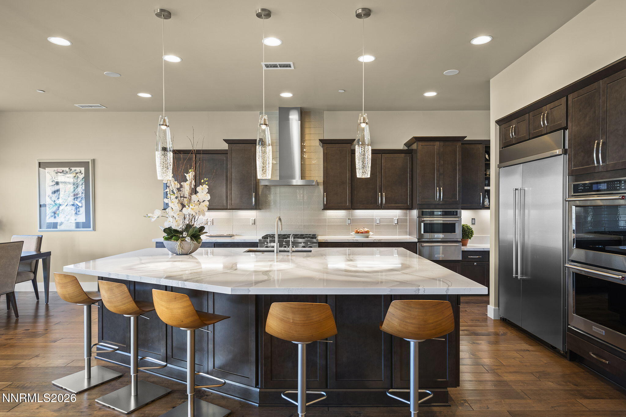 4856 Sierra Pine Court Reno, NV 89519 - Photo 18 of 71 a kitchen with stainless steel appliances kitchen island granite countertop a kitchen island and chairs in it