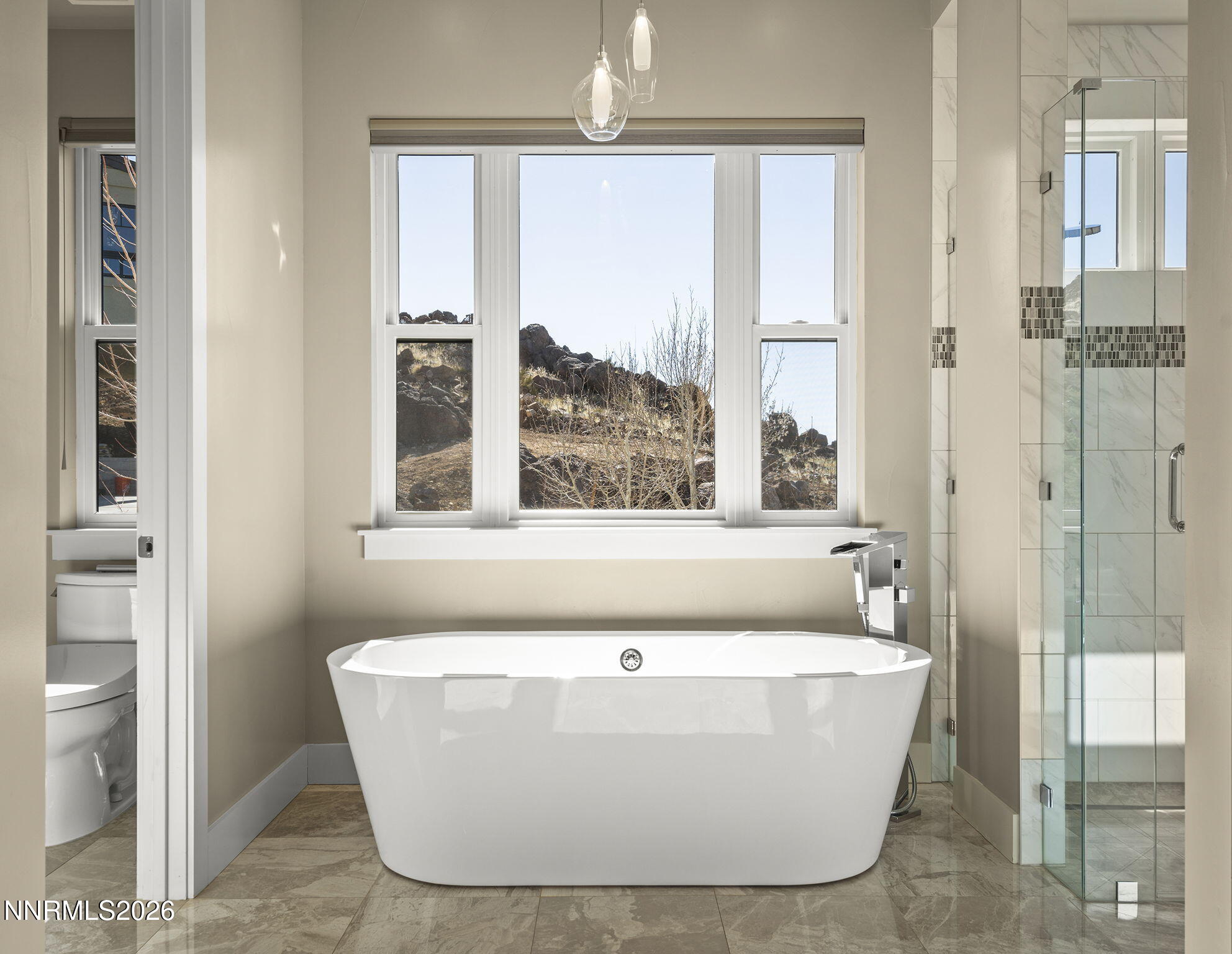 4856 Sierra Pine Court Reno, NV 89519 - Photo 27 of 71 a white bath tub sitting in a bathroom next to a window