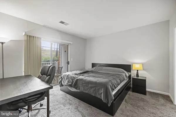 a bedroom with a bed and a table