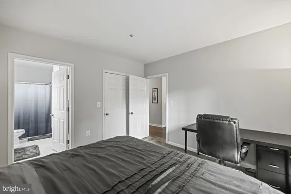 a bedroom with a bed and a fireplace