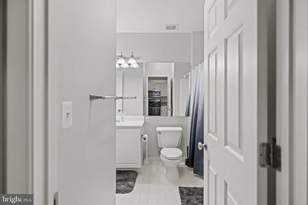 a bathroom with a toilet a sink and a mirror