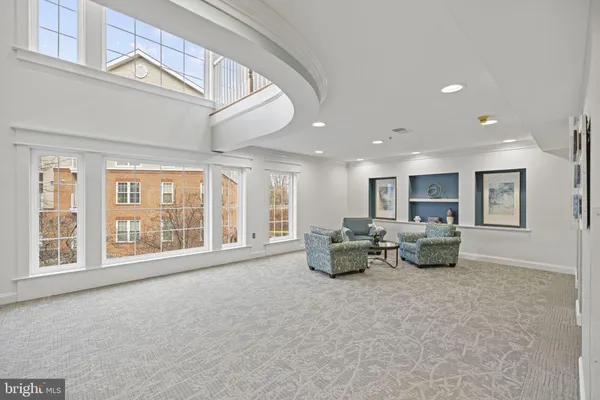 a living room with furniture and large windows