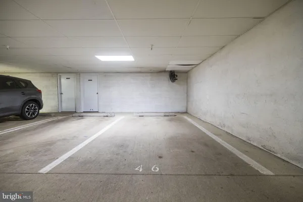 an empty room with a wooden door and car parked